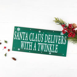 "Santa Claus delivers with a twinkle" Sign